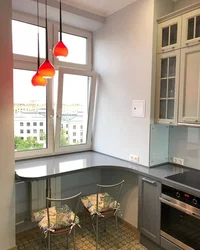 Photo of a kitchen with a table by the window photo