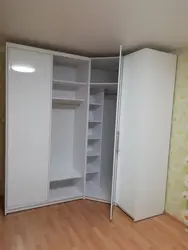Corner wardrobe for clothes in the bedroom with a mirror photo
