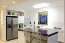 Refrigerator in the interior of the kitchen living room design