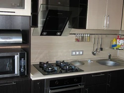 Black household appliances in the kitchen interior