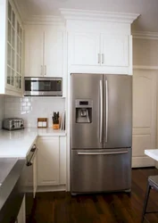 Refrigerator in the corner kitchen photo in the interior