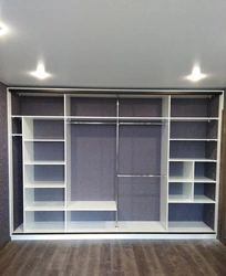 Built-in wardrobe in the living room along the entire wall photo inside