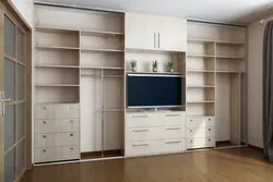 Built-in wardrobe in the living room along the entire wall photo inside