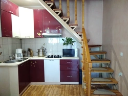 Kitchen with stairs to the second floor design photo