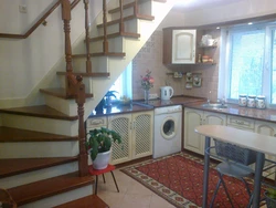 Kitchen with stairs to the second floor design photo