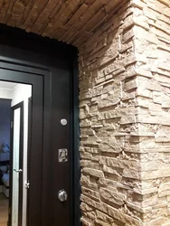Finishing doors with decorative stone in the hallway photo