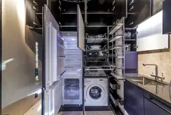 In the kitchen there is a washing machine and dishwasher photo