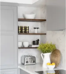 Photo of a kitchen with shelves and cabinets on the wall