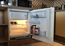 Built-in refrigerator in a small kitchen photo