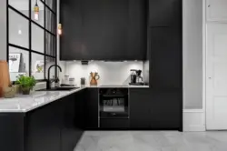 Photo Of A Kitchen With A Black Countertop And A Black Refrigerator