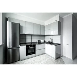 Photo of a kitchen with a black countertop and a black refrigerator