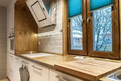 Window design in the kitchen in a wooden house