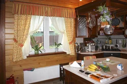 Window design in the kitchen in a wooden house