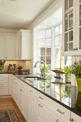 Design of a small kitchen in a house with a window