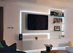 Shelves in the living room interior on the wall with a TV