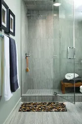 Bathtub and shower without tray in one room design