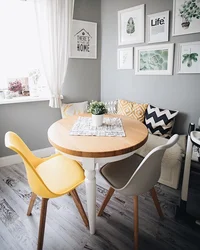 Photo of a kitchen with a round table against the wall