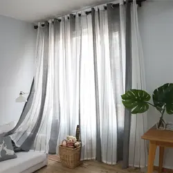 One curtain on the window in the bedroom with tulle photo
