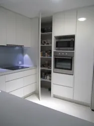 Photo of a corner kitchen with cabinets on only one wall