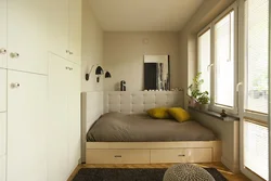 Bed along the wall in a small bedroom design