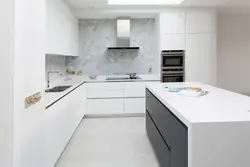Marble countertop and splashback in a white kitchen photo