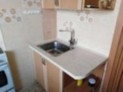 Sink and stove in the kitchen photo