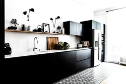 Black Refrigerator In The Interior Of A White Kitchen