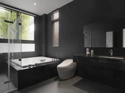 Black bathtub in the bathroom interior photo