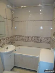 Photo of a bathtub after renovation with tiles in an apartment