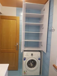 Cabinet above the washing machine in the bathroom photo in the interior