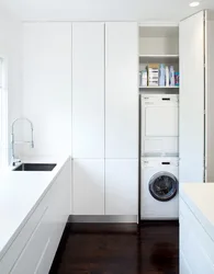 Cabinet above the washing machine in the bathroom photo in the interior