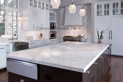 White kitchen with marble countertops in the interior photo