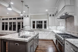 White Kitchen With Marble Countertops In The Interior Photo