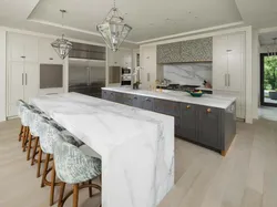 White kitchen with marble countertops in the interior photo