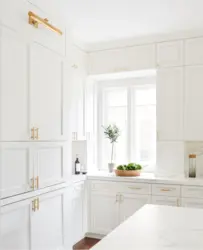 White kitchen with gold handles photo