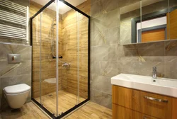 Photo of a bathtub with a shower screen without a tray