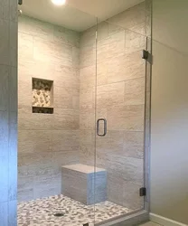Photo of a bathtub with a shower screen without a tray