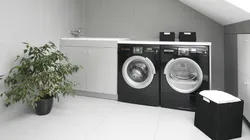 Black washing machine in the bathroom interior photo