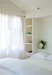 Small bedroom interior with white furniture