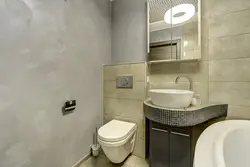 Bathtub with decorative plaster and tiles photo design