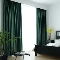 Emerald curtains in the bedroom interior