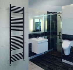 Black heated towel rail in the bathroom interior