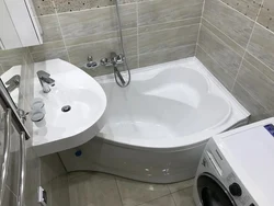 Corner Baths In A Small Bathroom With A Washing Machine Photo