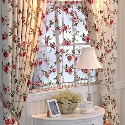 Curtains with flowers in the kitchen interior