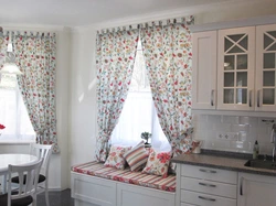 Curtains with flowers in the kitchen interior
