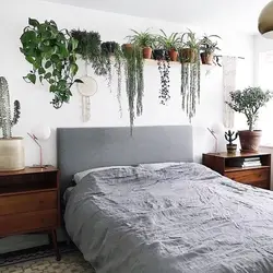 Photo of a bedroom with a flower above the bed
