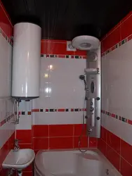 Photo of a small bathroom with a water heater
