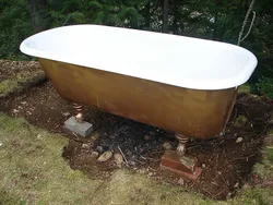 Cast iron bathtub in the countryside photo
