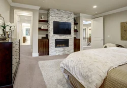 Bedroom with fireplace and TV photo