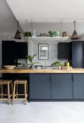 Concrete kitchen with wooden countertop in the interior